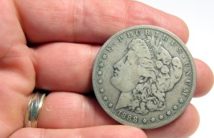 Hand Holding Old Silver Dollar